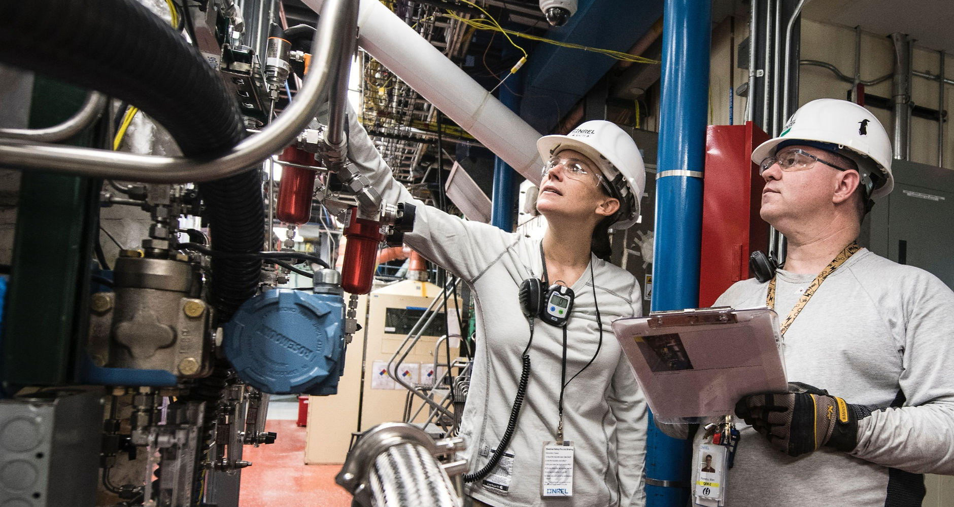 Control engineer and research technician performing equipment diagnostics during test
